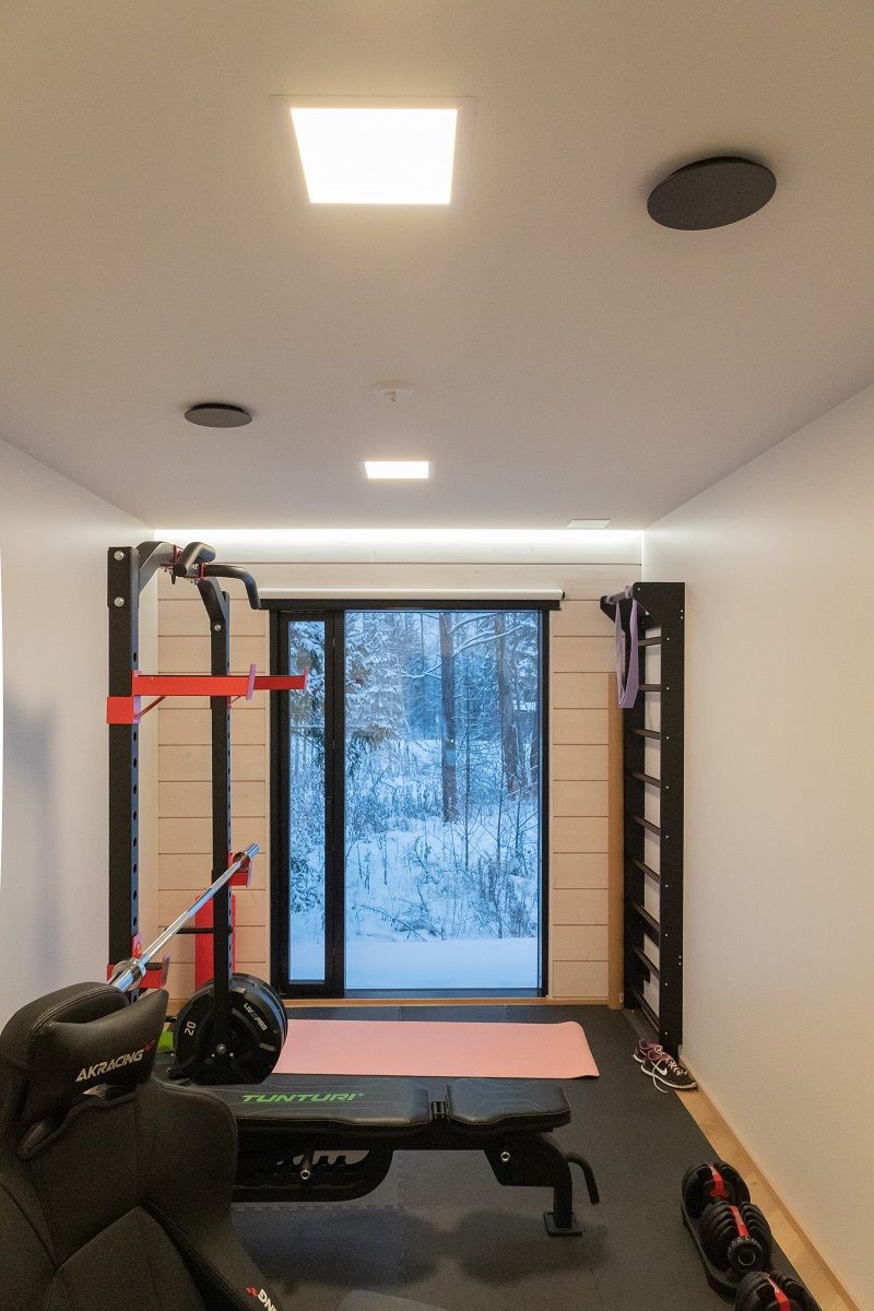In a hobby room, uniform general lighting with a square Paneeli 300 luminaire and indirect lighting with a LED strip on the wall/ceiling border to complement the lighting